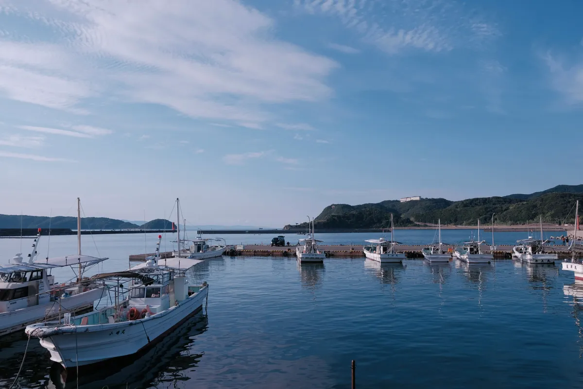 Vissershaven met afgemeerde boten en een kalme zee aan de kust van Wakayama